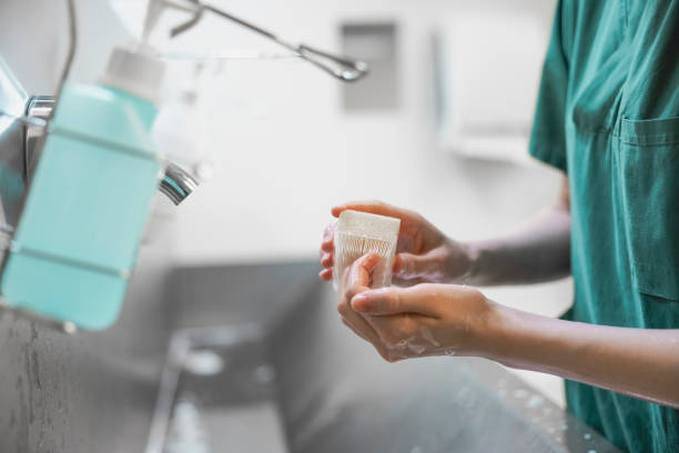 Person washing hands with soap under a faucet, illustrating the importance of hygiene after flu recovery.